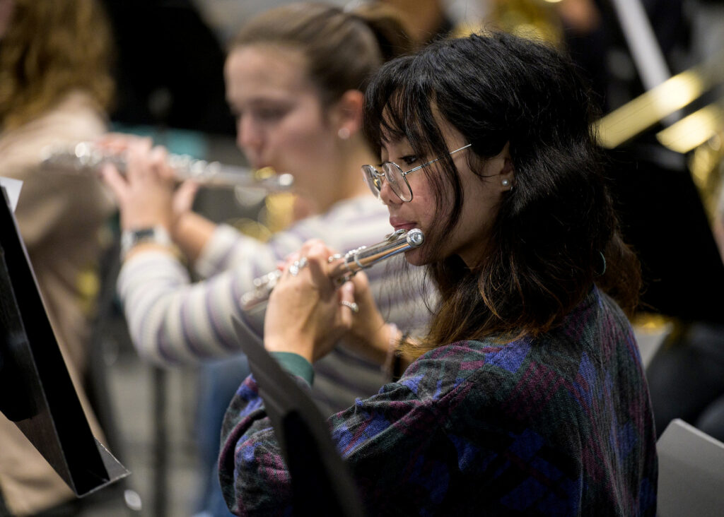 photo of students playing musical instruments as part of a wind ensemble